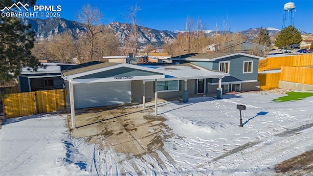 view of front of house with a mountain view and a garage