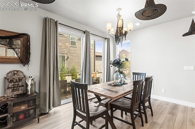 dining space with an inviting chandelier and light wood-type flooring