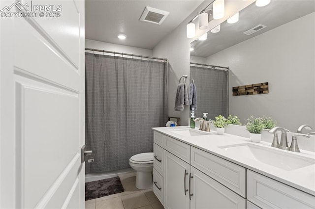 bathroom featuring tile patterned floors, toilet, and vanity