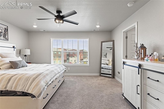 bedroom with ceiling fan and light colored carpet