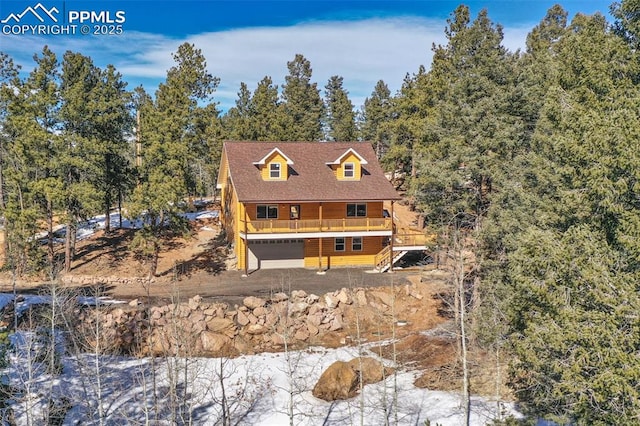 view of front of home featuring a garage and a wooden deck