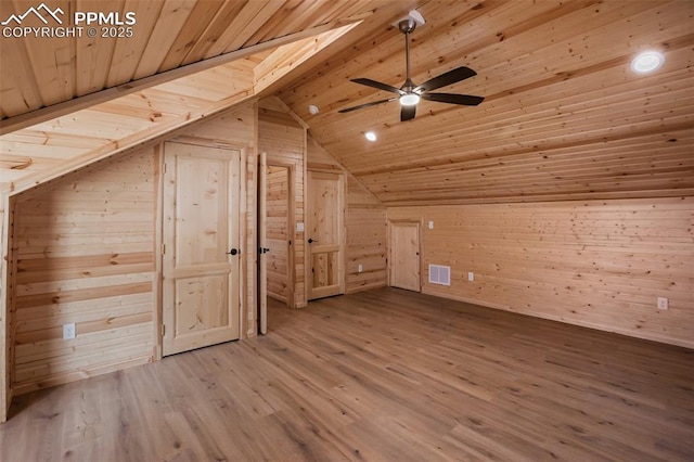 bonus room with hardwood / wood-style floors, wooden walls, lofted ceiling, ceiling fan, and wooden ceiling