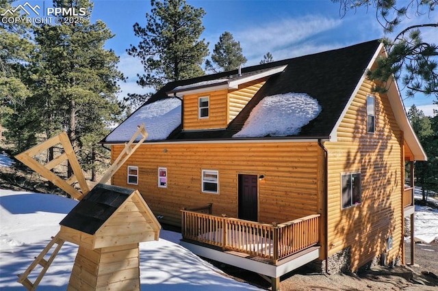 snow covered property featuring a wooden deck