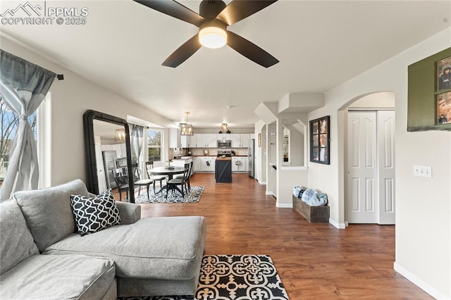 living room with ceiling fan and dark hardwood / wood-style floors