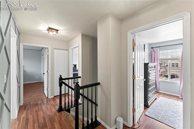 corridor with dark hardwood / wood-style floors