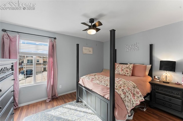 bedroom with ceiling fan, dark hardwood / wood-style floors, and multiple windows