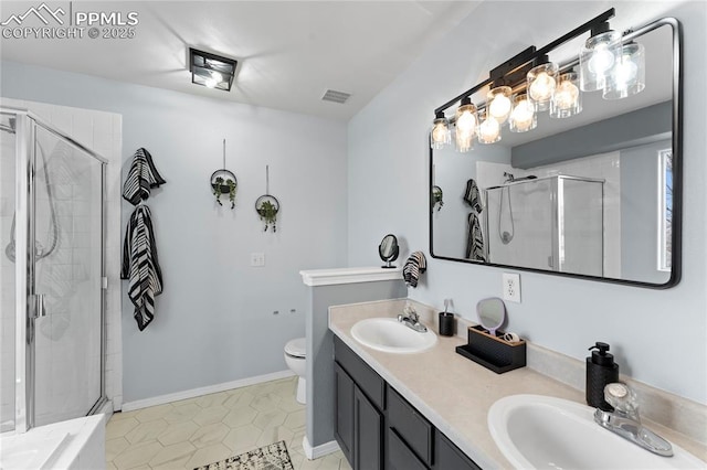 bathroom featuring toilet, vanity, tile patterned floors, and walk in shower