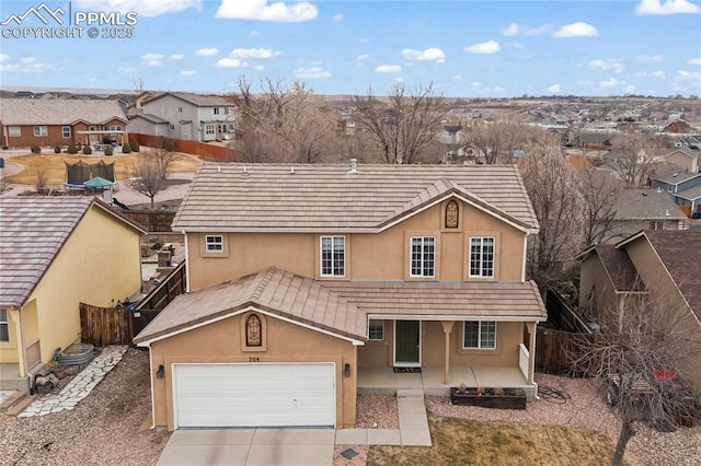 view of front of property with a porch and a garage