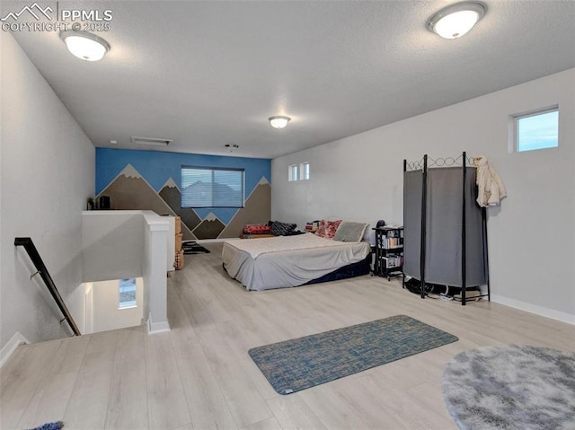 bedroom featuring a textured ceiling and light wood-type flooring