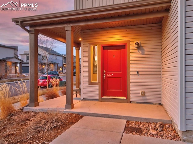 exterior entry at dusk with covered porch