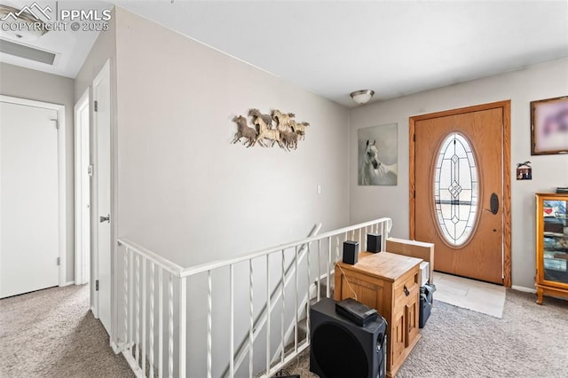 entryway with light colored carpet