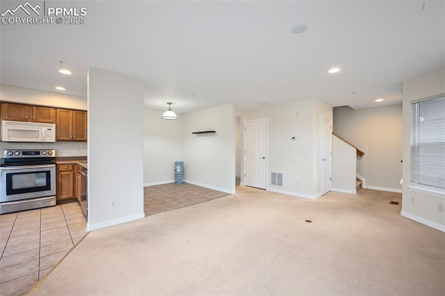 interior space with stainless steel electric stove and light colored carpet