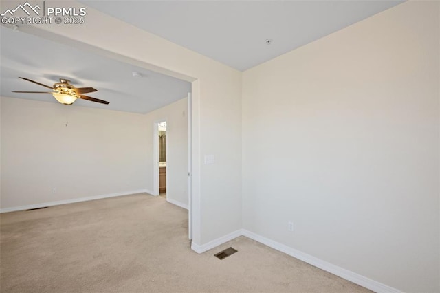 spare room featuring ceiling fan and light carpet