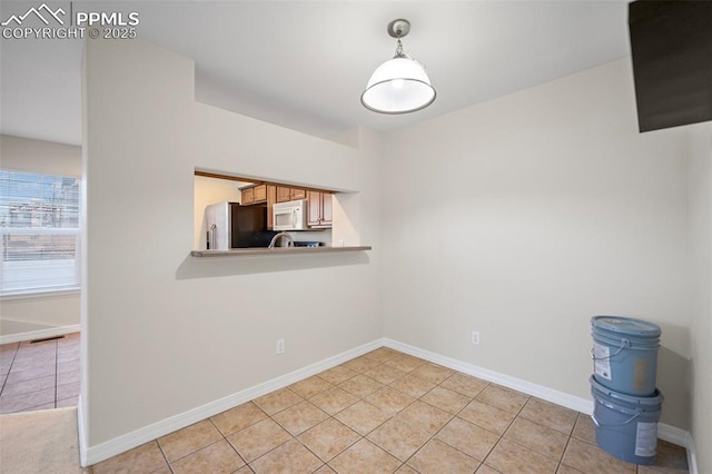 spare room with light tile patterned floors