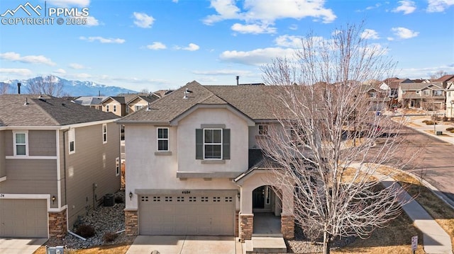 view of front of home featuring a garage and a mountain view