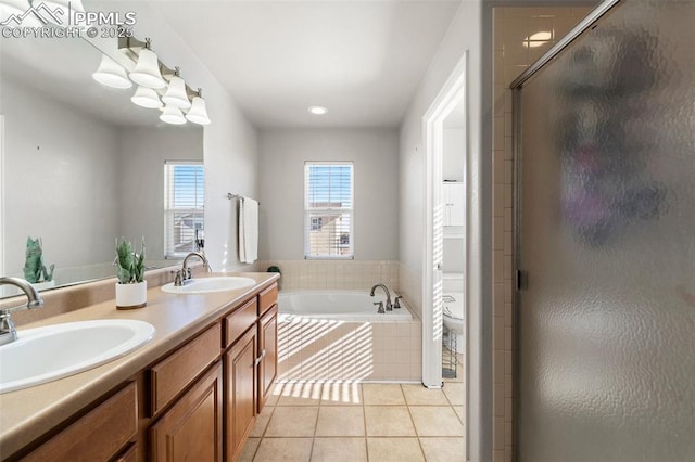 full bathroom featuring toilet, vanity, shower with separate bathtub, and tile patterned flooring