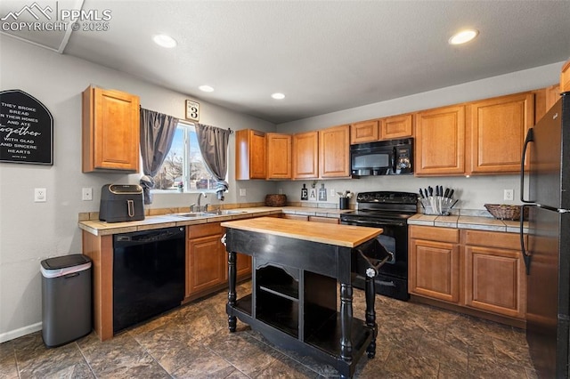 kitchen featuring wood counters, sink, and black appliances