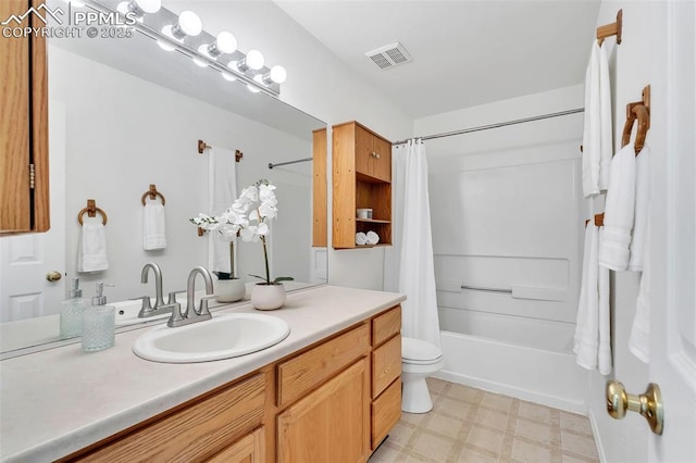 full bathroom with vanity, shower / tub combo, and toilet