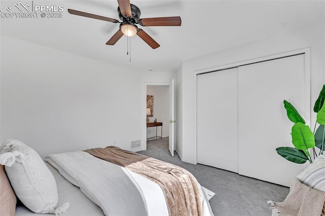 bedroom with ceiling fan, carpet floors, and a closet