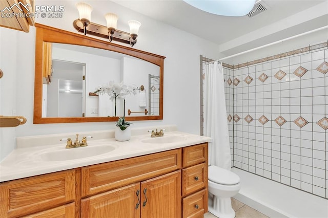 bathroom featuring a shower with curtain, vanity, tile patterned floors, and toilet