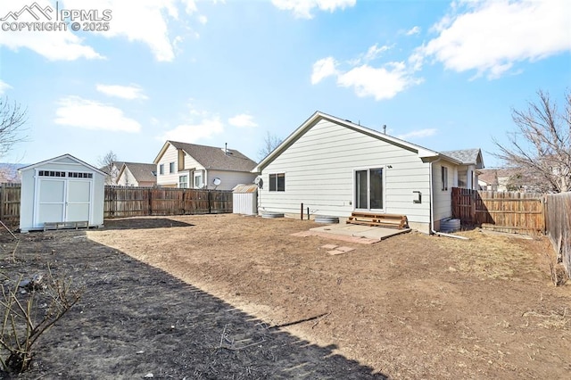 rear view of property with a storage shed and a patio