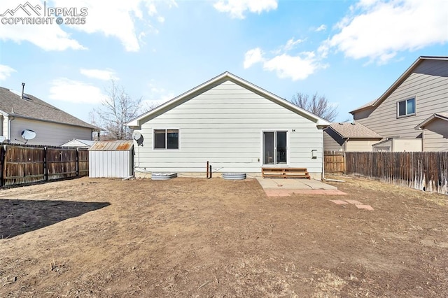 rear view of property with a patio area and a shed