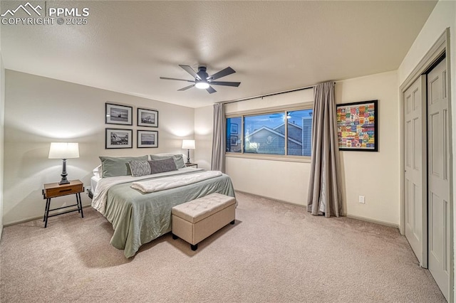 bedroom with carpet floors, ceiling fan, and a closet