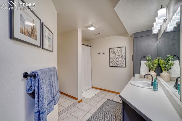 bathroom featuring tile patterned flooring and vanity