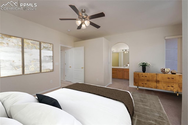 carpeted bedroom featuring ensuite bathroom and ceiling fan