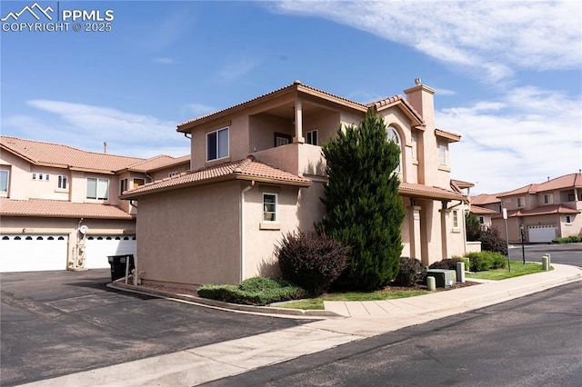 mediterranean / spanish house with a garage