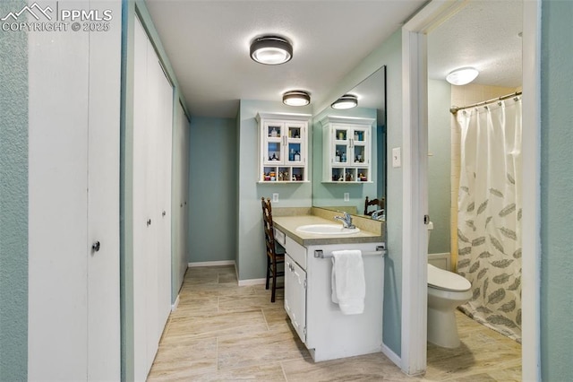 full bath featuring curtained shower, toilet, wood finished floors, vanity, and baseboards