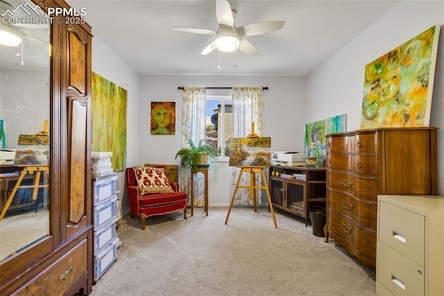 sitting room with a ceiling fan and light colored carpet