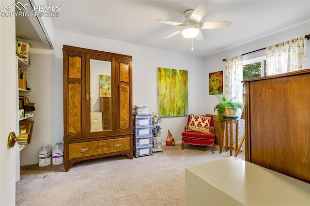 sitting room with carpet and a ceiling fan