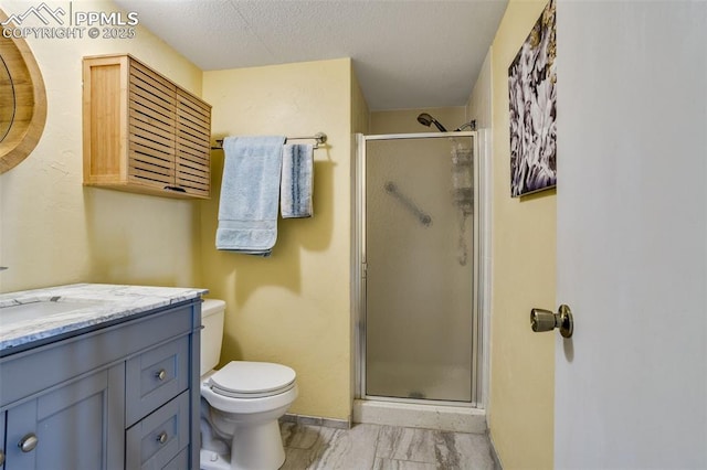 full bath with toilet, a stall shower, vanity, a textured ceiling, and baseboards