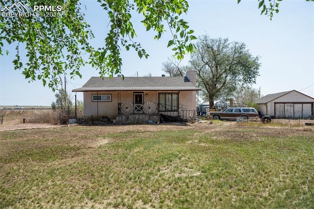 rear view of house featuring a lawn