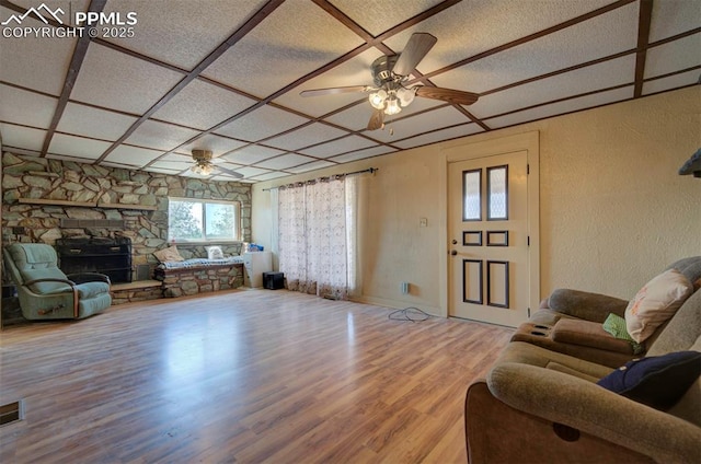 living room with coffered ceiling, hardwood / wood-style floors, and ceiling fan