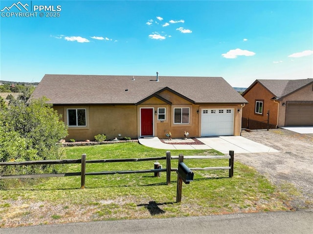 ranch-style home featuring a garage, fence, driveway, stucco siding, and a front lawn