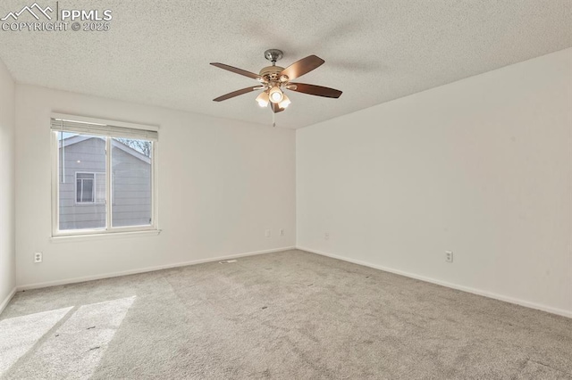 unfurnished room with ceiling fan, light carpet, and a textured ceiling