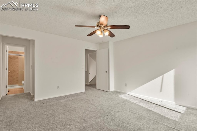 carpeted empty room with ceiling fan and a textured ceiling