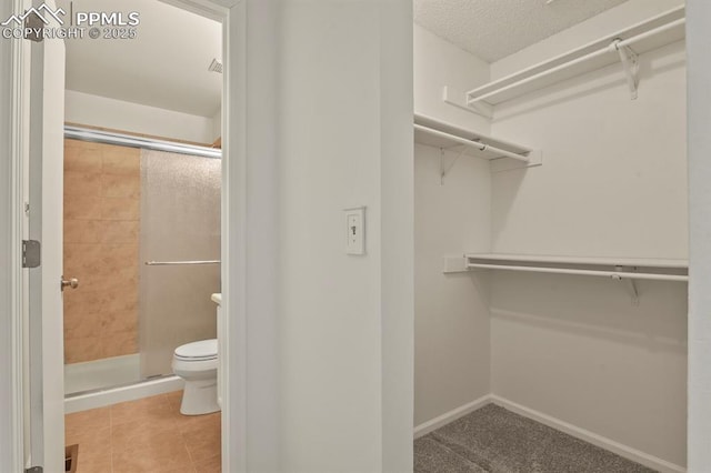 spacious closet featuring tile patterned floors