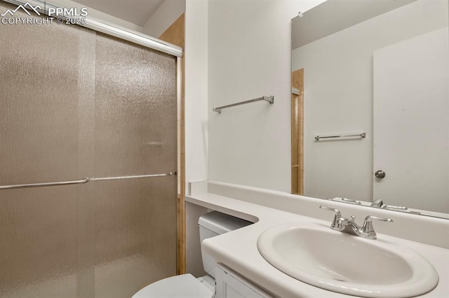 bathroom with vanity, an enclosed shower, and toilet