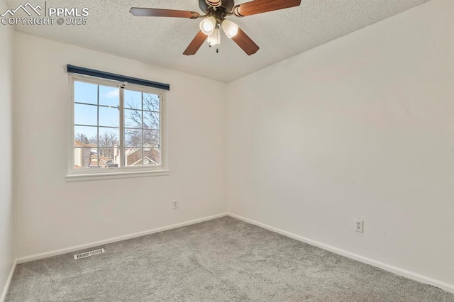 spare room with ceiling fan, carpet floors, and a textured ceiling