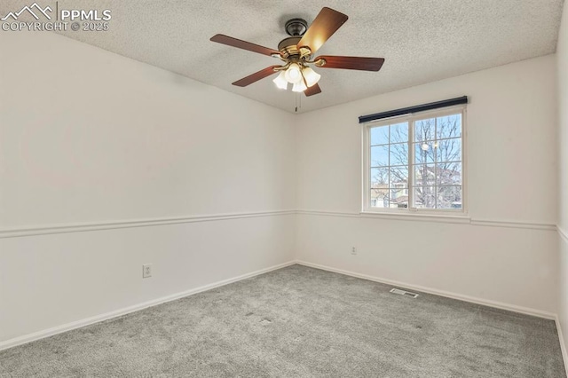 unfurnished room featuring ceiling fan, carpet, and a textured ceiling