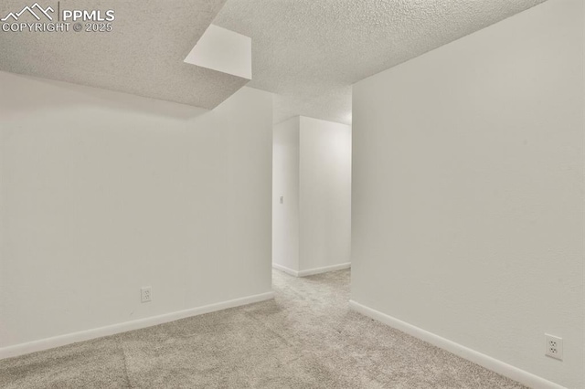 carpeted spare room with a textured ceiling