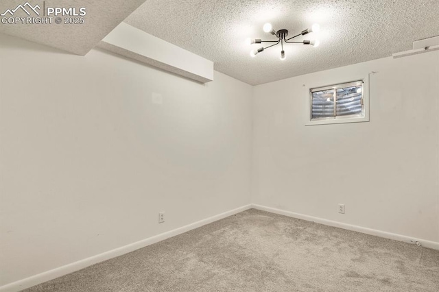 carpeted spare room with a textured ceiling