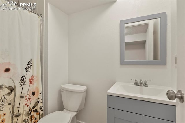 bathroom featuring vanity, toilet, and a shower with shower curtain