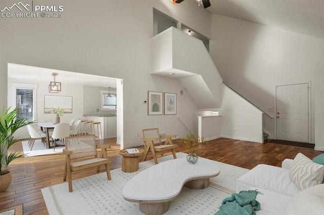 living room with dark hardwood / wood-style floors and high vaulted ceiling