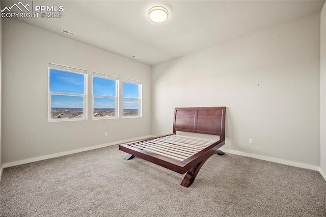 bedroom with carpet, visible vents, and baseboards