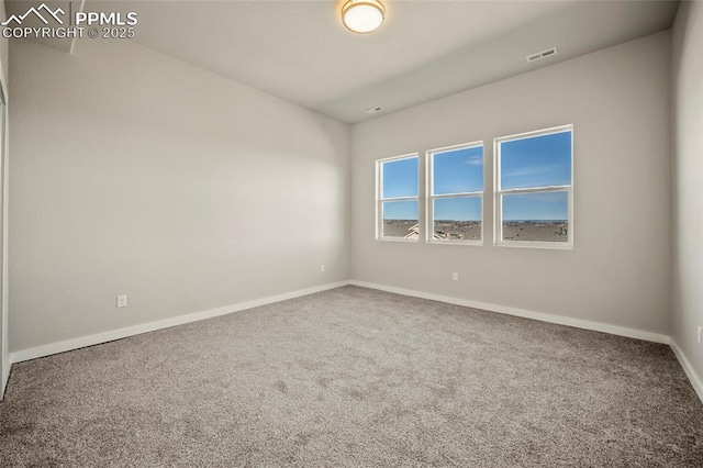 carpeted empty room featuring visible vents and baseboards