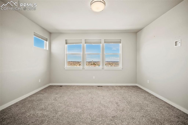 carpeted spare room with baseboards